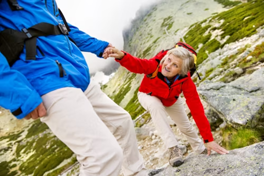 :** Senior couple walking mindfully through a forest trail, surrounded by trees.