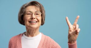 A calm senior adult with an emergency kit bag, looking prepared and confident while holding a flashlight
